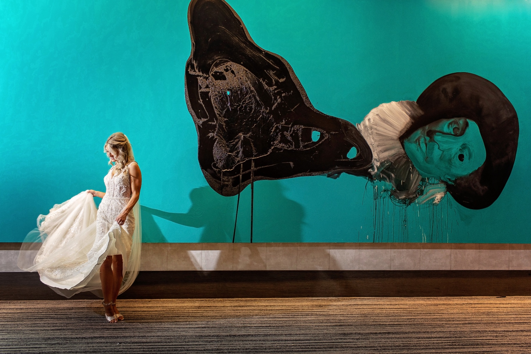 Bride laughing on a floral swing with bridesmaids