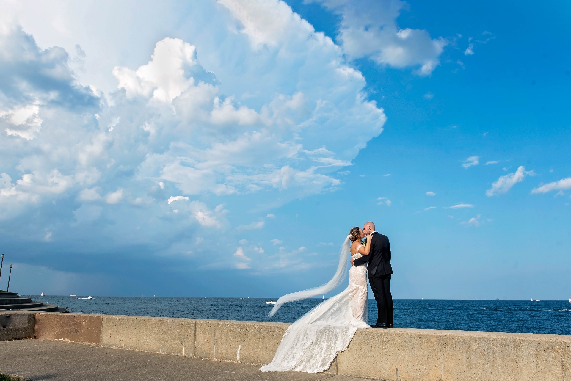 Bride and groom with city skyline across the lake