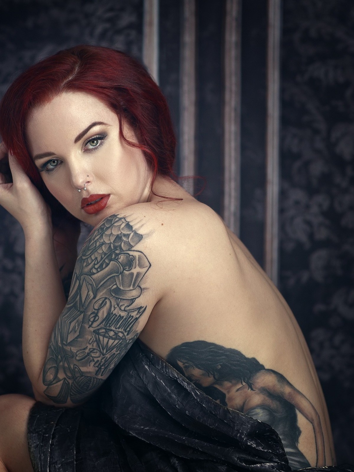 Boudoir portrait against a dark textured backdrop