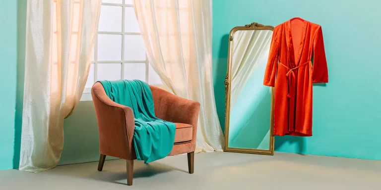 Elegant boudoir style options like robes and a velvet chair in a cozy room for your session.
