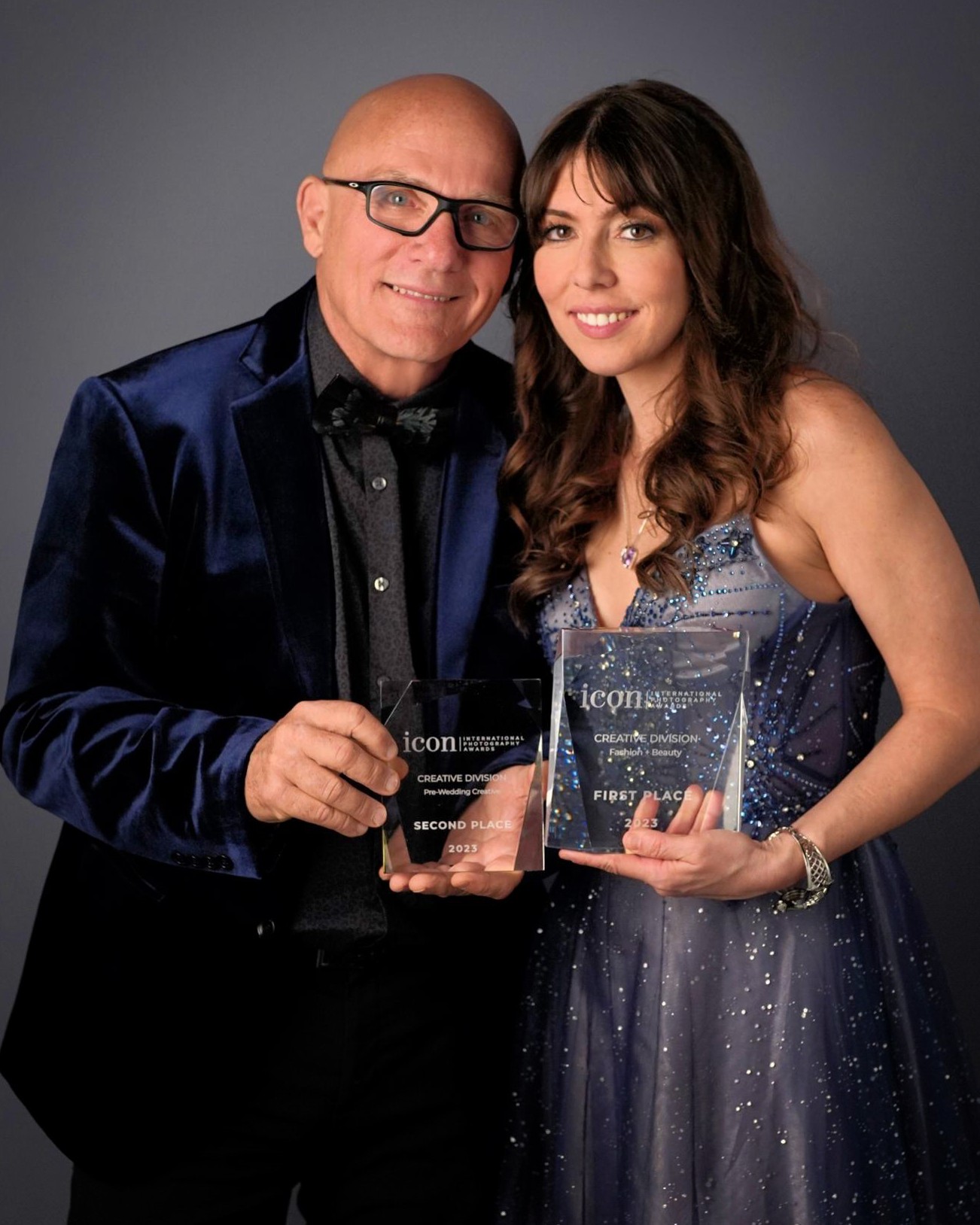 Jeff and Rachel Owen holding the international photography awards they have won