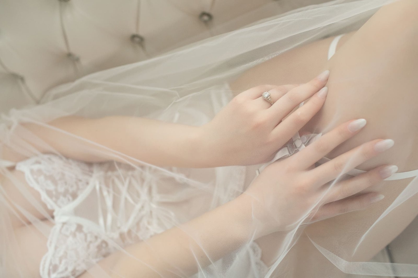 Soft detail of a bride's veil, lace, and wedding ring from Lindsay's boudoir session