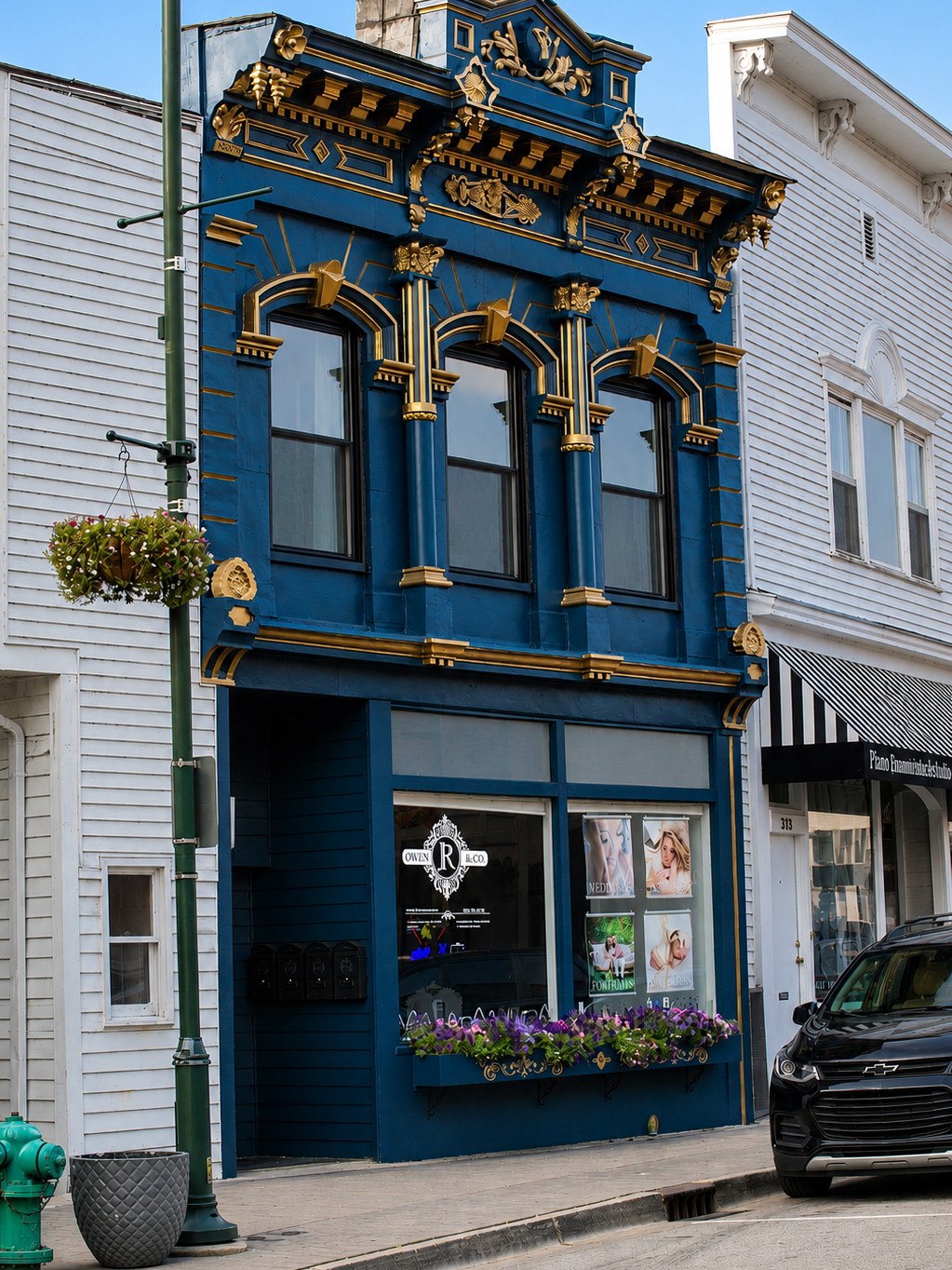 The studio's historic two-story storefront on Canal Street, painted deep navy with gilded Victorian detailing